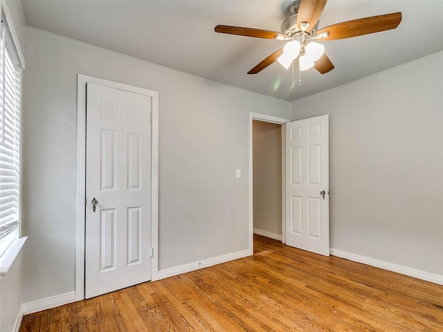 unfurnished bedroom with a closet, light hardwood / wood-style floors, and ceiling fan