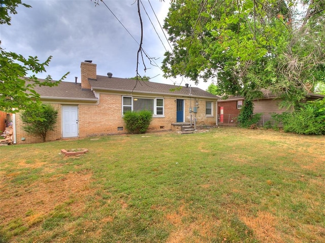 back of property featuring a yard