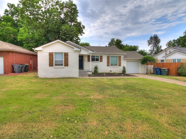 ranch-style house featuring a front lawn and a garage