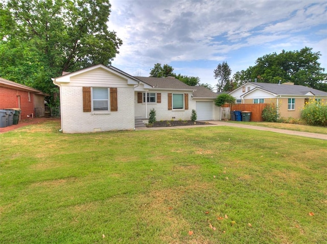 single story home featuring a garage and a front lawn