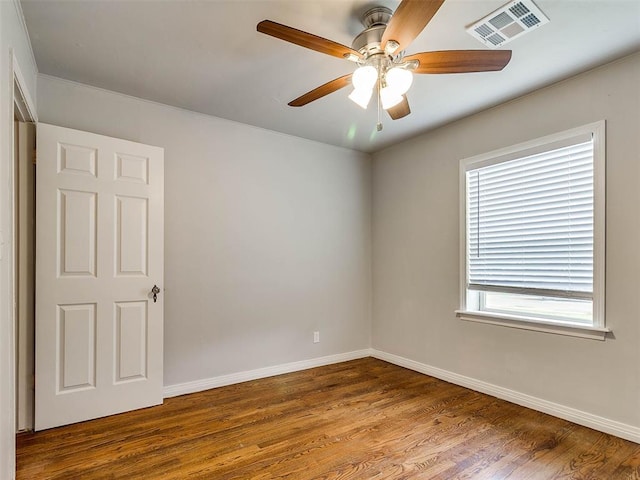 empty room with hardwood / wood-style flooring and ceiling fan