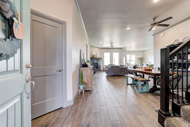 interior space featuring hardwood / wood-style flooring, ceiling fan, and crown molding