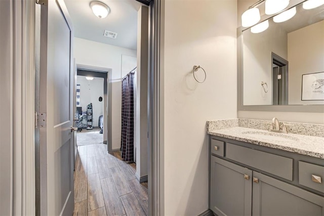 bathroom featuring vanity, hardwood / wood-style flooring, and walk in shower