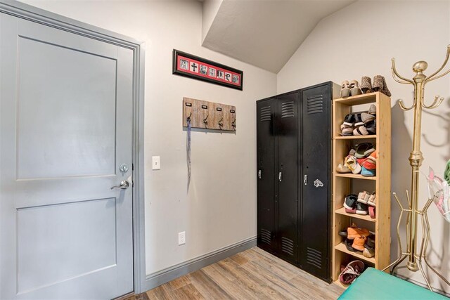 mudroom with hardwood / wood-style flooring and vaulted ceiling