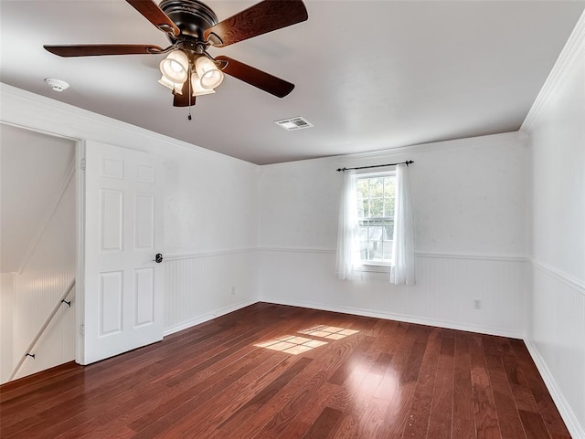 spare room with ceiling fan, hardwood / wood-style floors, and crown molding