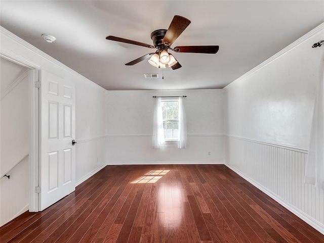 unfurnished room featuring dark hardwood / wood-style floors, ceiling fan, and ornamental molding