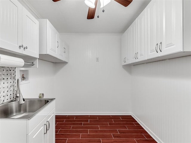 washroom featuring cabinets, hookup for a washing machine, dark hardwood / wood-style flooring, and crown molding