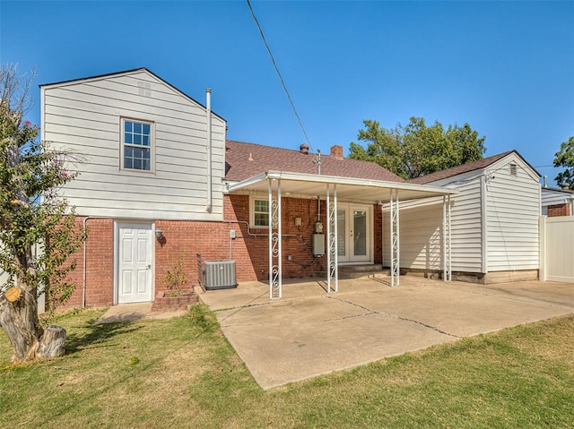 rear view of house with a yard, a patio, and central air condition unit