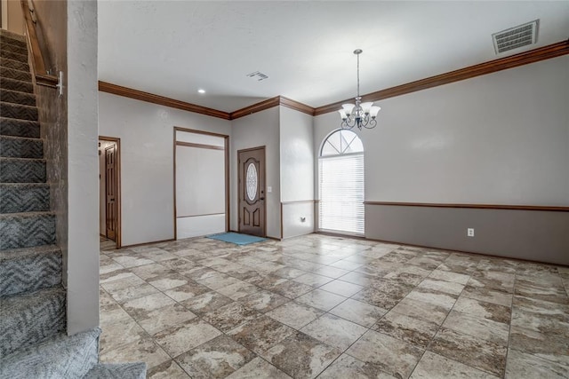 foyer entrance featuring crown molding and a chandelier