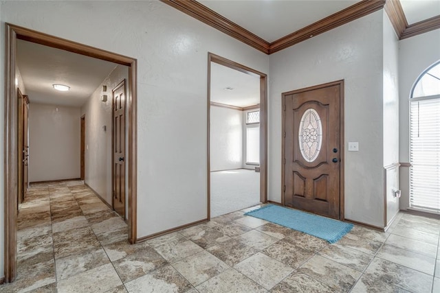 foyer entrance featuring crown molding