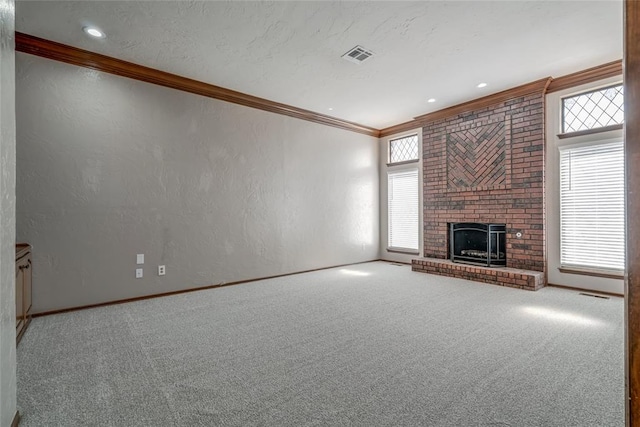 unfurnished living room featuring a fireplace, carpet floors, and ornamental molding