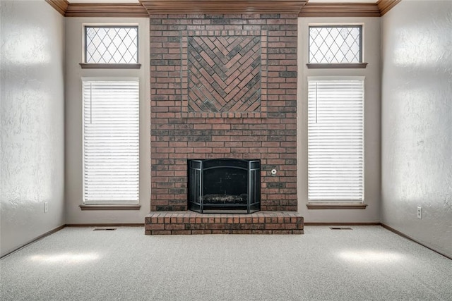 unfurnished living room featuring a brick fireplace, carpet floors, and ornamental molding