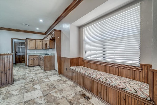 kitchen with crown molding and wood walls