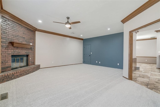 unfurnished living room featuring a brick fireplace, ceiling fan, light carpet, and ornamental molding