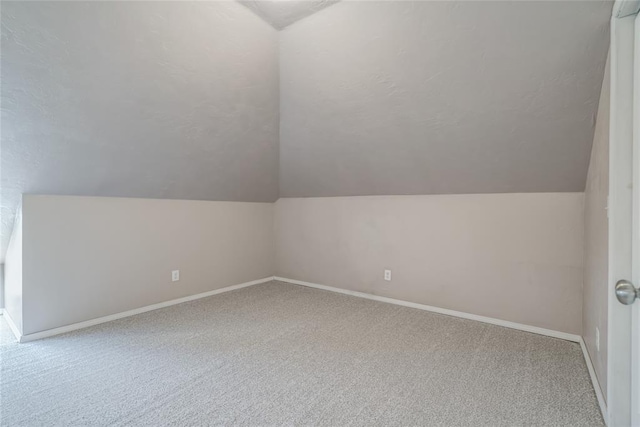 bonus room featuring carpet floors and lofted ceiling