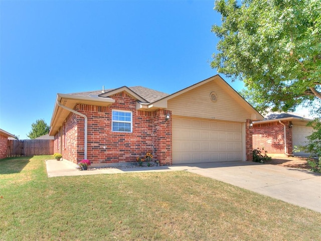 ranch-style home with a front yard and a garage