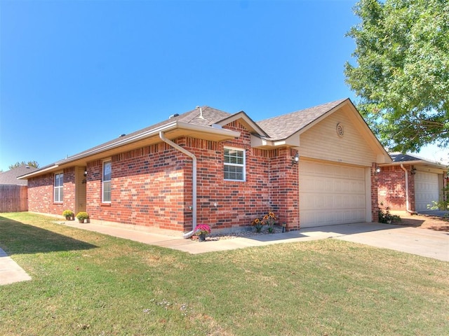 ranch-style house featuring a garage and a front lawn