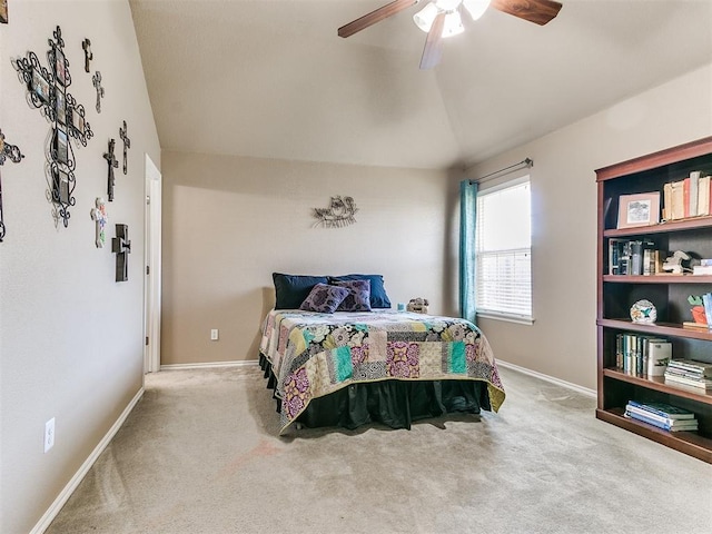 bedroom with light colored carpet, vaulted ceiling, and ceiling fan