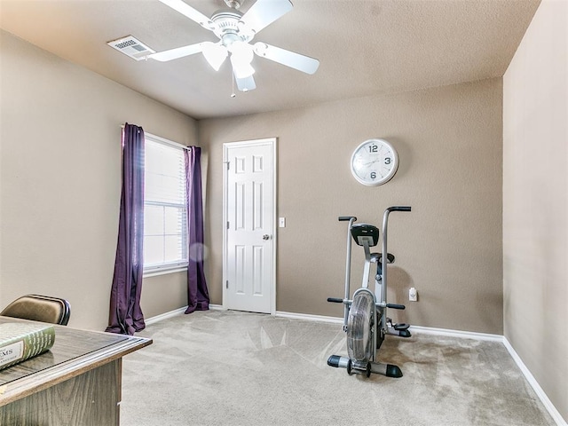 exercise area with ceiling fan and light carpet