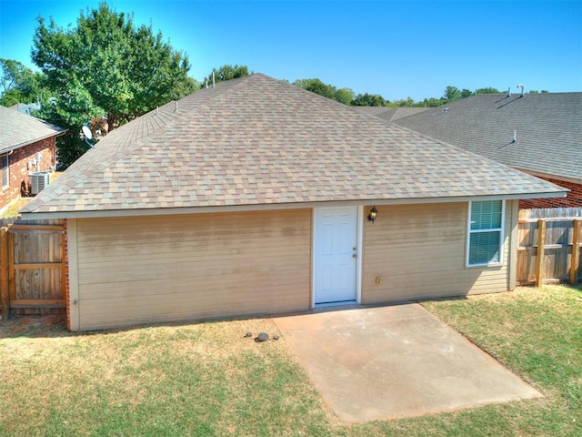 ranch-style home with a patio area, central air condition unit, and a front yard