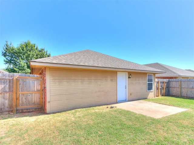 back of property featuring a patio and a lawn