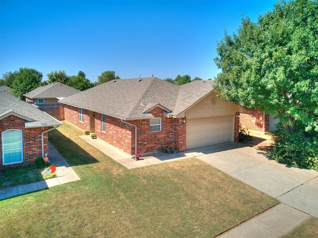 view of front of property with a front yard and a garage