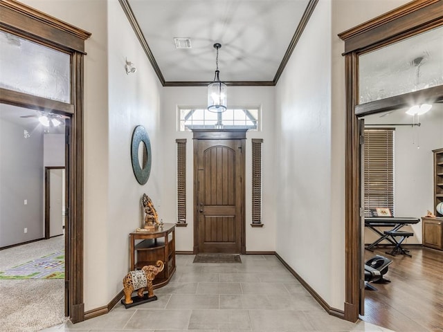 entryway featuring light wood-type flooring and crown molding