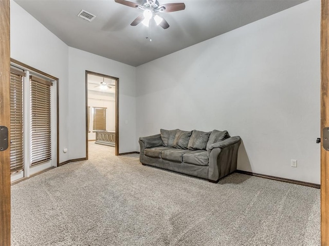 living room with light carpet and ceiling fan