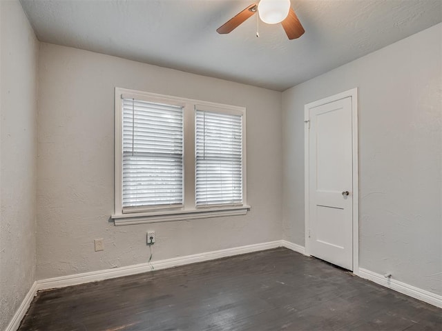 unfurnished room featuring dark hardwood / wood-style flooring and ceiling fan