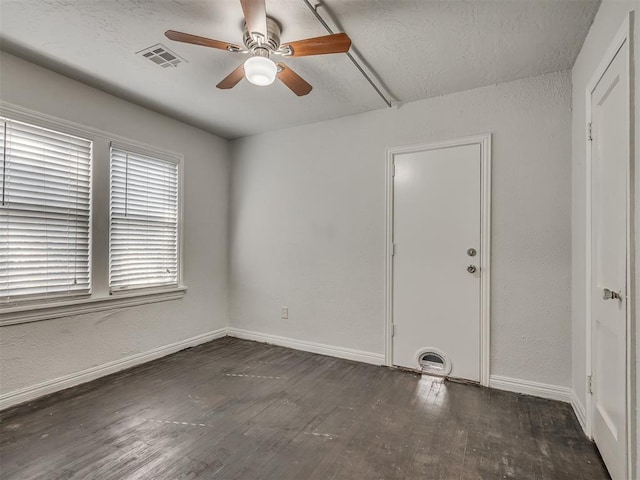 spare room featuring ceiling fan and dark hardwood / wood-style flooring