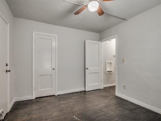 unfurnished bedroom with dark hardwood / wood-style flooring and ceiling fan