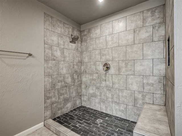 bathroom featuring a tile shower