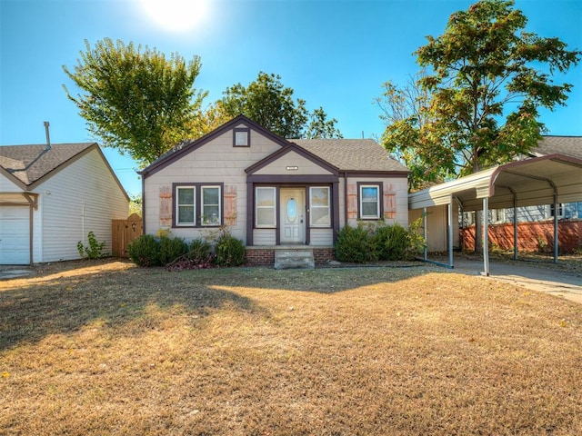 view of front facade with a carport and a front yard