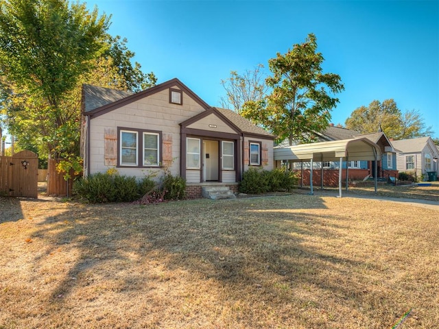 single story home featuring a front yard and a carport