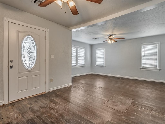 entrance foyer with a textured ceiling, dark hardwood / wood-style floors, and ceiling fan