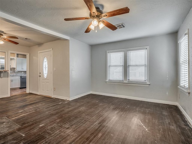 foyer entrance with dark hardwood / wood-style flooring and a wealth of natural light