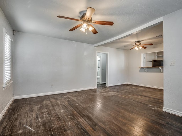 spare room with ceiling fan and dark wood-type flooring