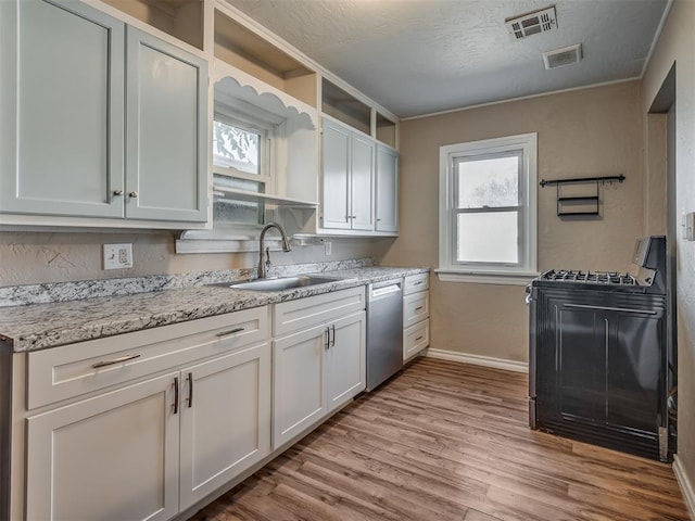 kitchen featuring black range, dishwasher, a healthy amount of sunlight, and sink