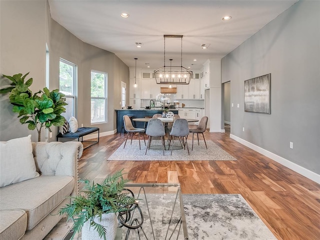 dining room featuring a chandelier, hardwood / wood-style floors, and sink