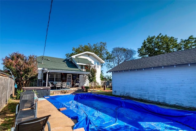 view of pool featuring a patio and a hot tub