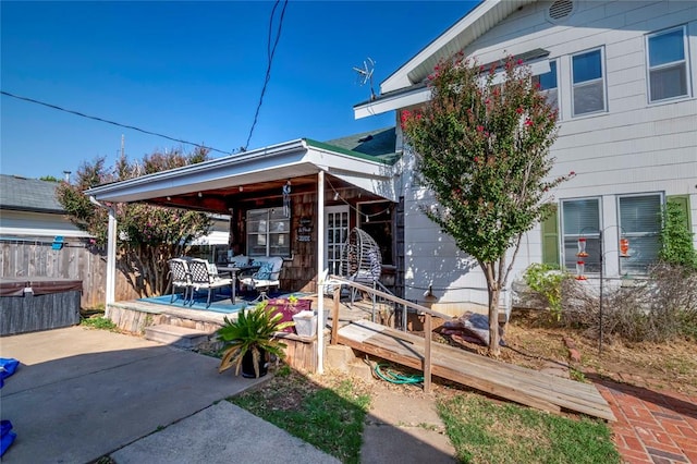 exterior space featuring a patio and a hot tub