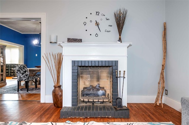 interior details with wood-type flooring and a fireplace