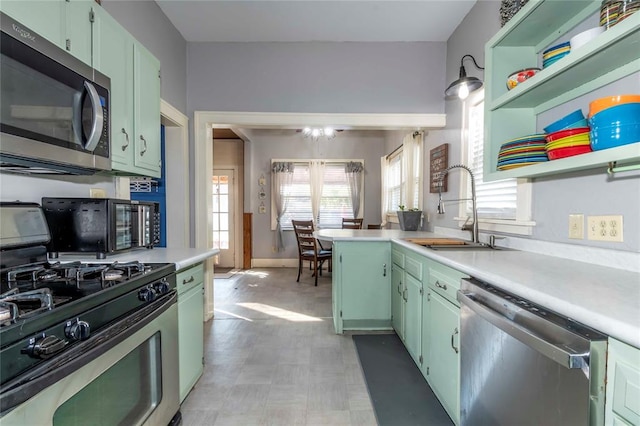 kitchen featuring green cabinets, sink, and appliances with stainless steel finishes