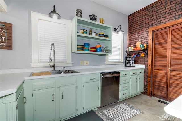 kitchen with sink, brick wall, and stainless steel dishwasher