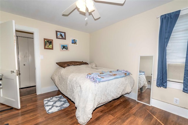 bedroom with ceiling fan, dark hardwood / wood-style flooring, and a closet