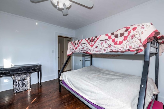 bedroom featuring dark hardwood / wood-style flooring, ceiling fan, and crown molding