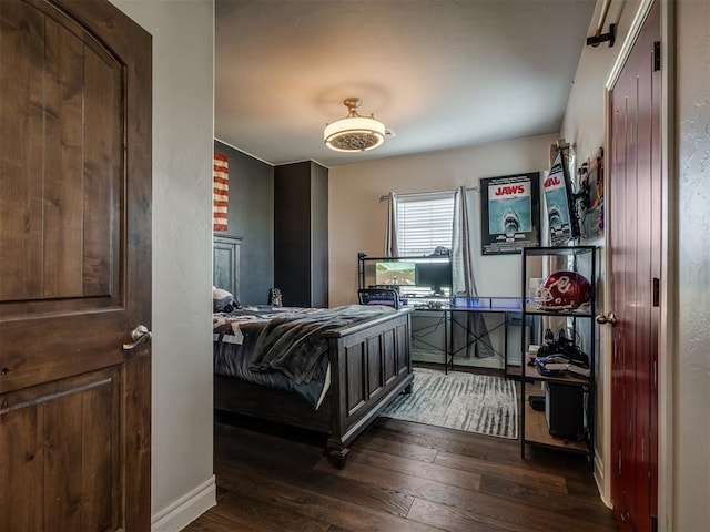 bedroom with dark wood-type flooring