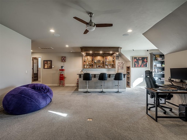 interior space with ceiling fan and indoor bar