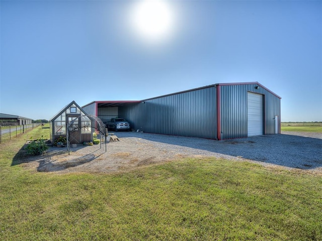 exterior space with a lawn, a garage, and a carport