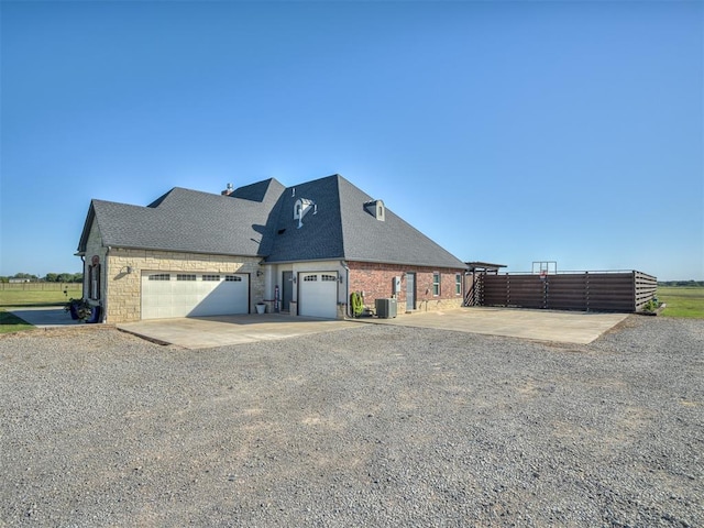 exterior space with cooling unit and a garage